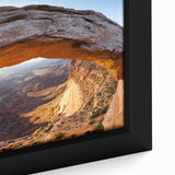 Framed canvas featuring a textured depiction of Canyonlands in Utah with a predominantly black foreground and colorful…