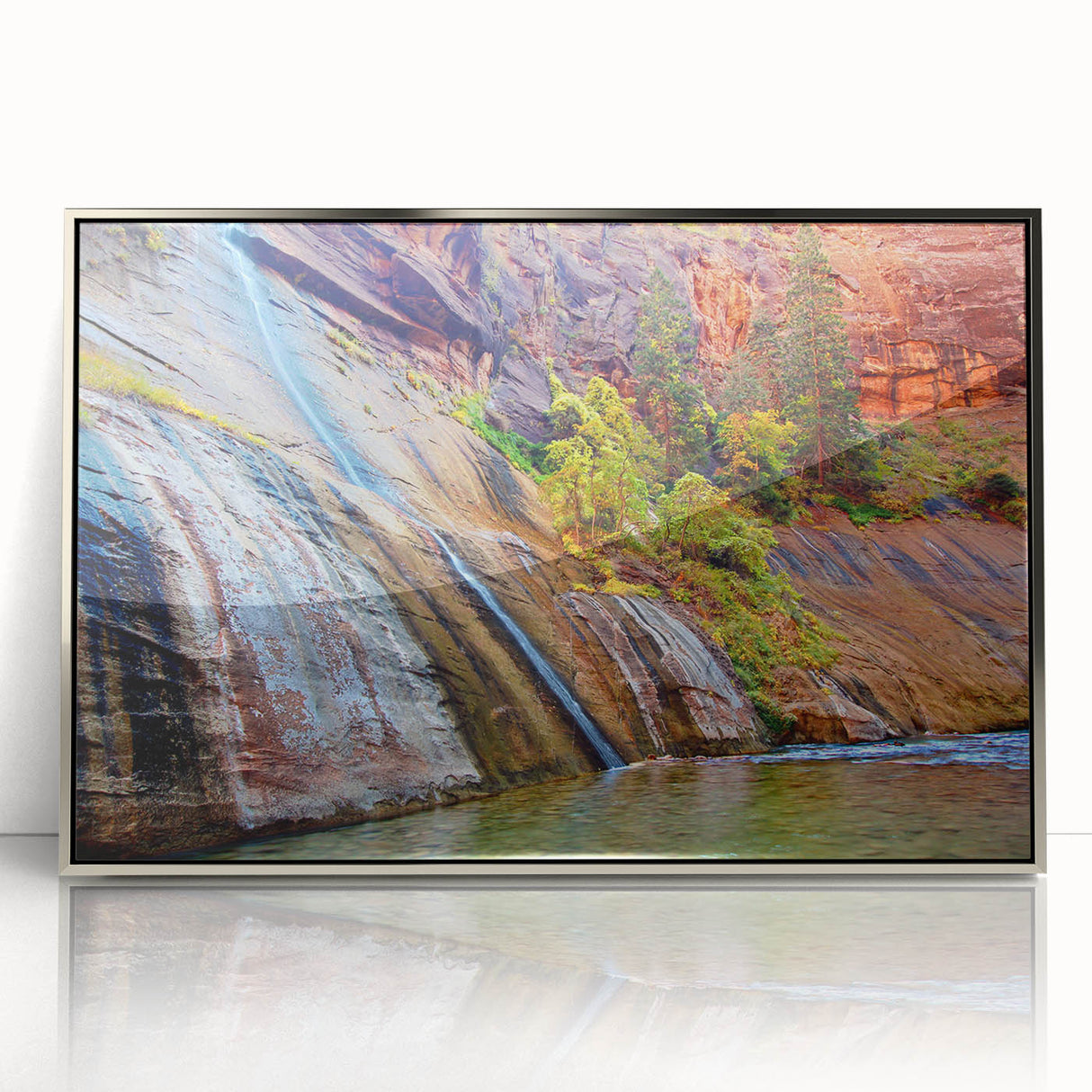 Mid-century modernist art depicting Zion National Park in vibrant earth tones on a silver-framed acrylic print.