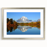Textured art print of Wyoming's Grand Tetons in muted earth tones, framed in silver, ideal for bedroom decor.