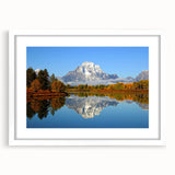 Abstract art print of the Grand Tetons with muted earth tones on a framed white mat, ideal for dining room decor.