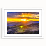 Abstract art print depicting Yellowstone scenery in muted earth tones on a framed white mat, suitable for dining room decor.