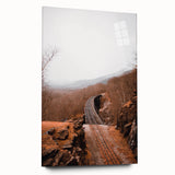 Large abstract wall art depicting autumn trees in earthy orange and brown tones on acrylic glass.