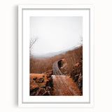 Abstract art print featuring swirling autumnal hues on a white framed canvas, suitable for bedroom or dining room decor.