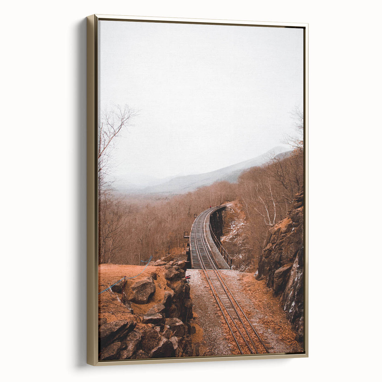 Framed canvas depicting a vintage-style landscape painting of autumn trees, in muted gold and black tones.