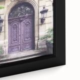 Close-up of a black framed canvas featuring a textured painting of a colorful French door.