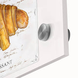 Close-up of large abstract wall art featuring assorted pastries in vibrant colors on acrylic glass.