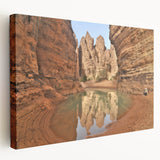 A stretched canvas depicting a serene Algerian landscape in earthy tones, ideal for kitchen wall art.