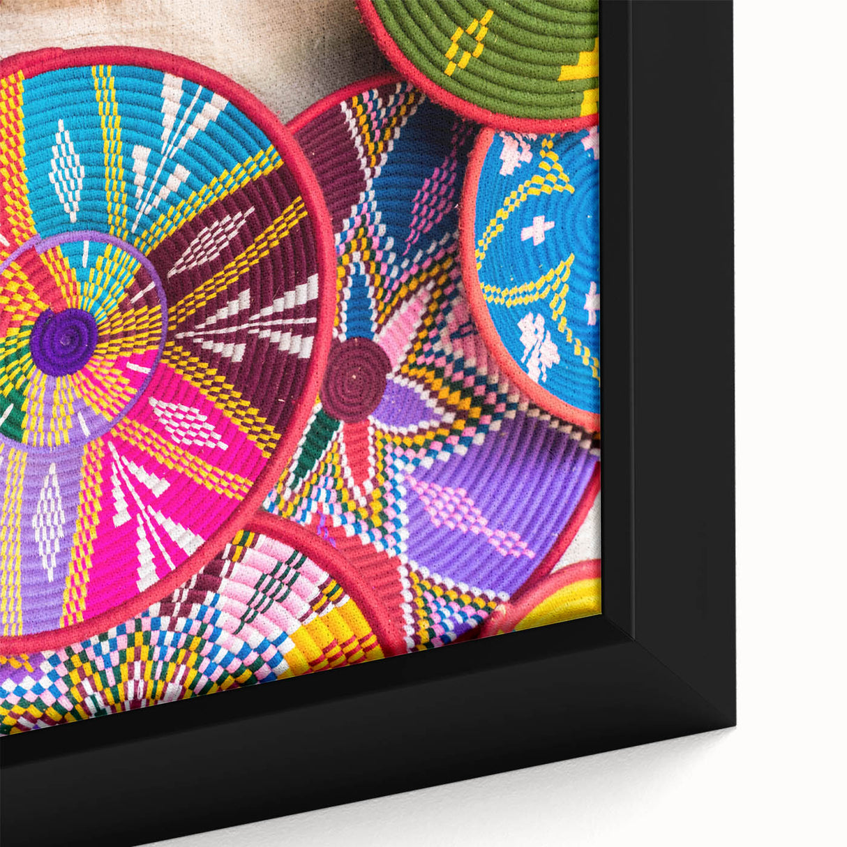 Close-up of a textured black wall art featuring a colorful Ethiopian scenery on a framed canvas.