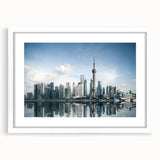 Abstract art print of Shanghai skyline in muted gray and blue tones, framed with a white mat.