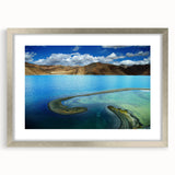 Textured abstract art print depicting a serene Tibetan landscape in muted earth tones, framed in silver.