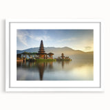 Abstract art print of an Indonesian landscape in muted green and blue tones, framed with a white mat.