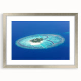 Textured art print of Maldives scenery in muted blue and white, framed in silver, suitable for bedroom art.