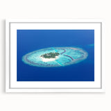 Abstract art print of a serene Maldivian landscape in soft blue and white tones, framed with a white mat.