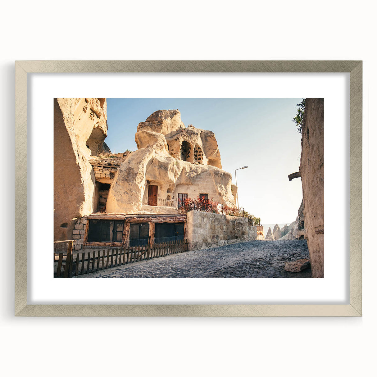 Textured abstract art print of a Turkish landscape in muted earth tones, framed with a silver mat, ideal for bedroom art.