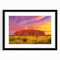 Extra large abstract art print of Ayers Rock in colorful, textured style, framed with a black mat.