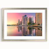 Abstract art print of Brisbane skyline in muted gray and blue tones, framed with a silver mat.