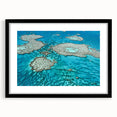 Colorful abstract art print of the Great Barrier Reef in vibrant blues and greens, framed in black.