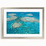 Abstract art print of the Great Barrier Reef in blue and green tones on a framed canvas, ideal for dining room decor.