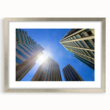 Abstract art print of Perth skyline in muted blue and gray, framed in silver, ideal for dining room decor.