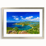 Abstract art print of Caribbean scenery in muted blue and green tones, framed in silver, ideal for living room decor.