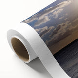 Art deco poster of a tropical Caribbean beach on rolled canvas, featuring pastel blue and pink hues.