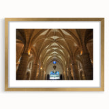 Abstract art print depicting Caribbean scenery in muted blues and greens, framed in gold.