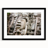 Extra large abstract art print of a Central American scenery in vibrant colors, framed in black.