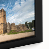 Close-up of a black wall art on framed canvas depicting a colorful, textured Central American scenery.