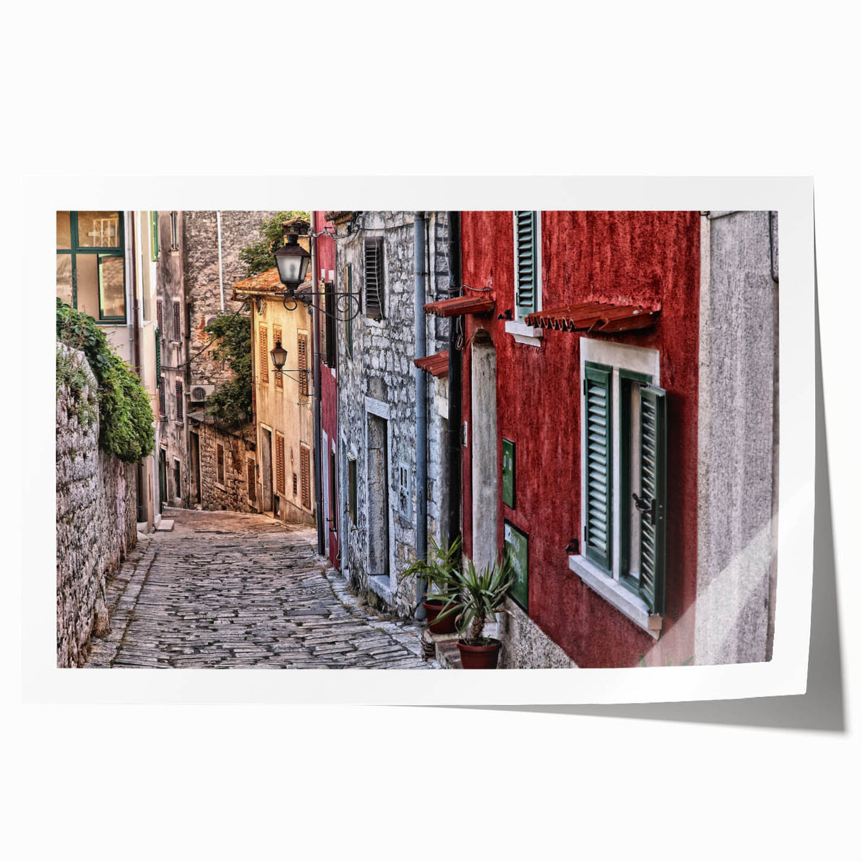 Rolled print of a Croatian landscape featuring vibrant green fields and a clear blue sky.