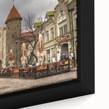 Close-up of a textured black wall art featuring a colorful Estonian landscape on a framed canvas.