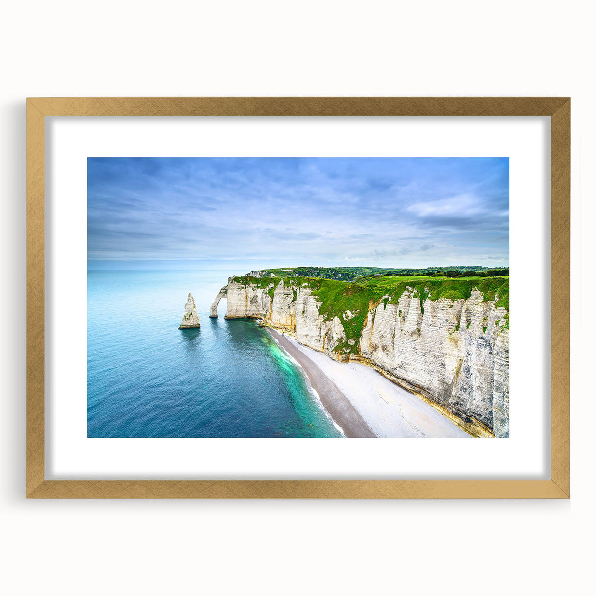 Abstract art print depicting the Normandy coastline in muted blue and green tones, framed in gold.