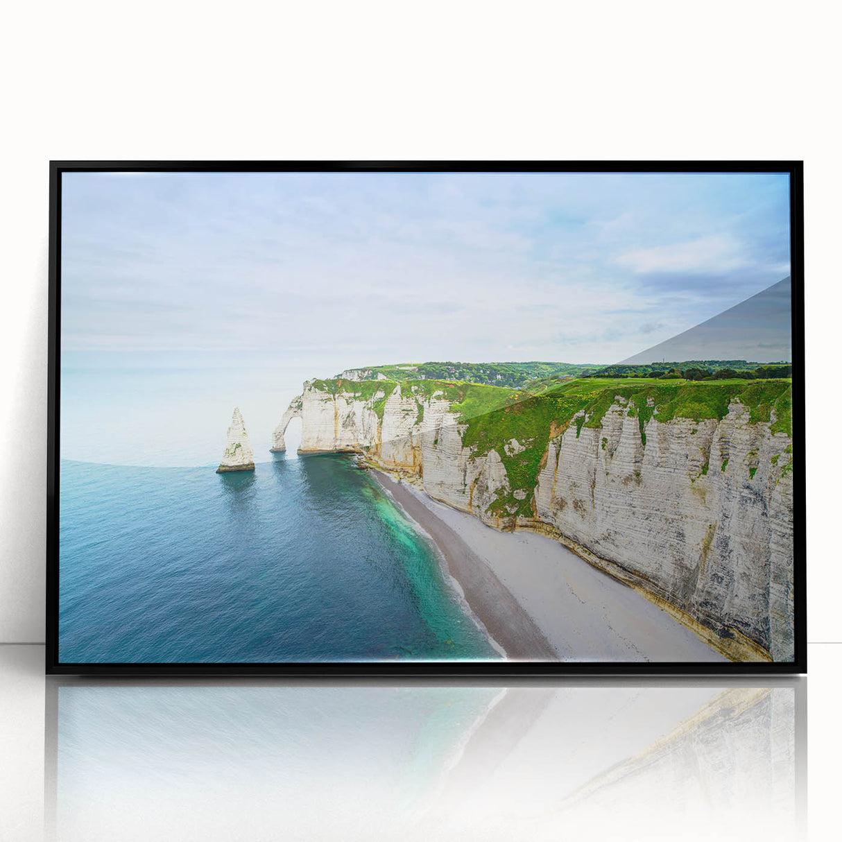 Large abstract wall art depicting the Normandy coast in muted blues and grays, framed in black acrylic.