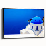 Vintage poster art of Santorini with colorful buildings on a black framed canvas, ideal for living room decor.
