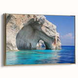 Framed canvas featuring a vintage-style landscape painting of a Greek coastal village in muted gold and black tones.