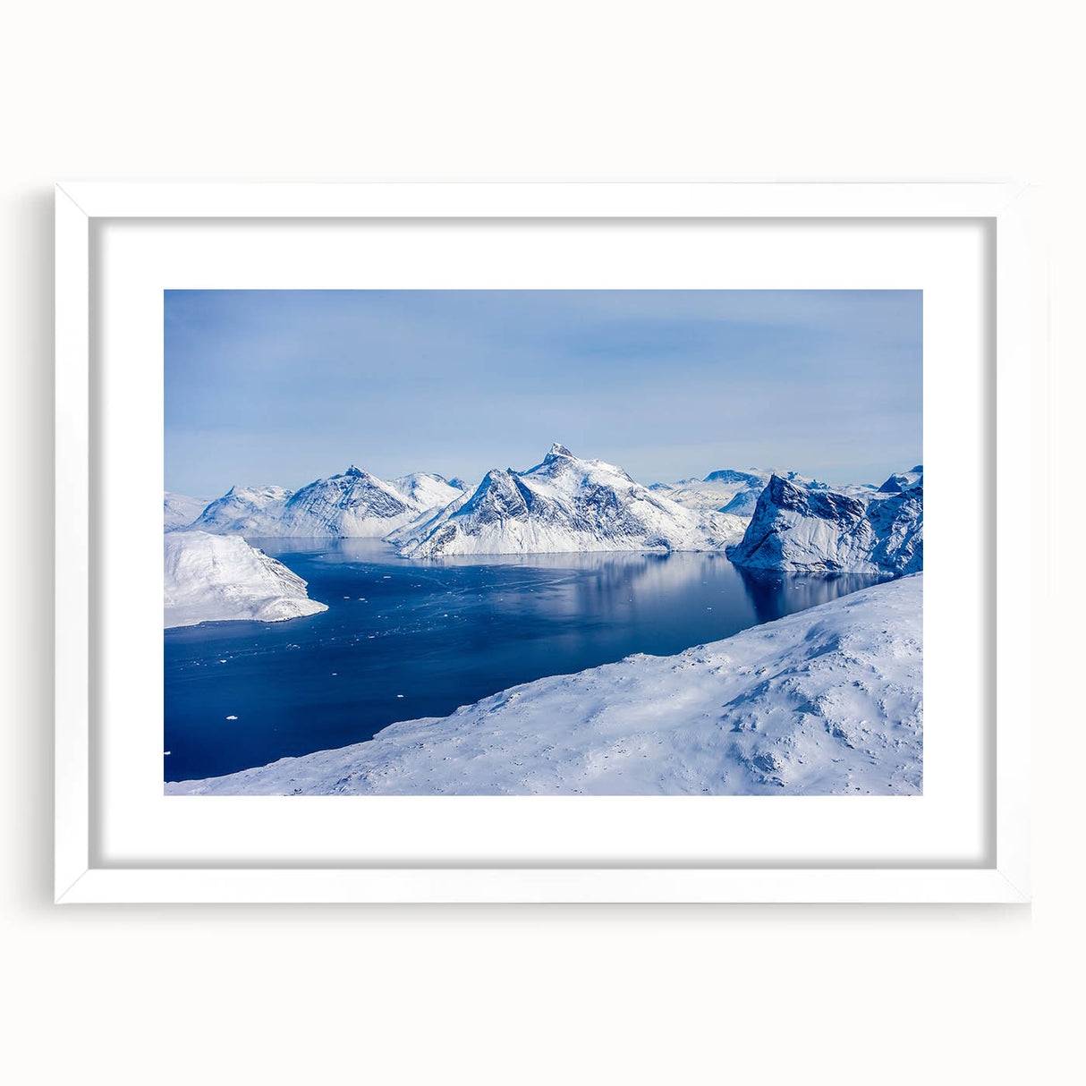 Textured abstract art print of a Greenlandic landscape in muted green and blue tones, framed with a white mat.