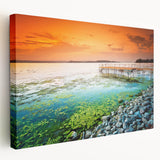 Landscape painting of a European countryside on a stretched canvas, featuring muted green and earth tones.