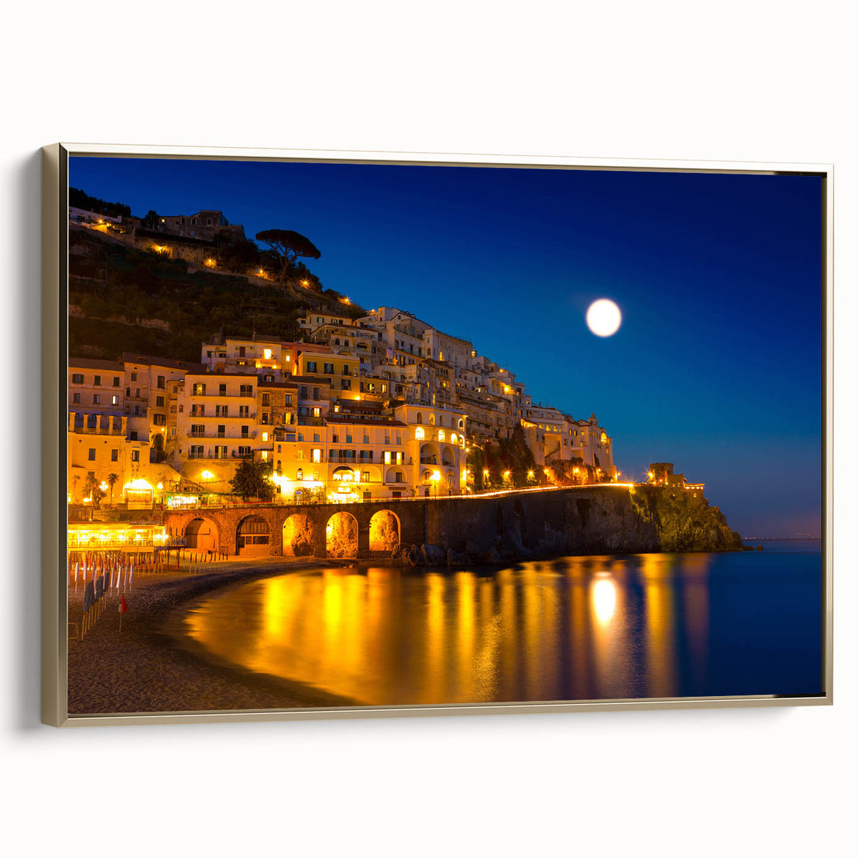 Framed canvas of Amalfi Coast landscape with vintage poster art style in muted gold and black tones.