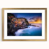 Abstract art print of Cinque Terre with vibrant blue and pastel hues on a gold-framed canvas, suitable for dining room decor.