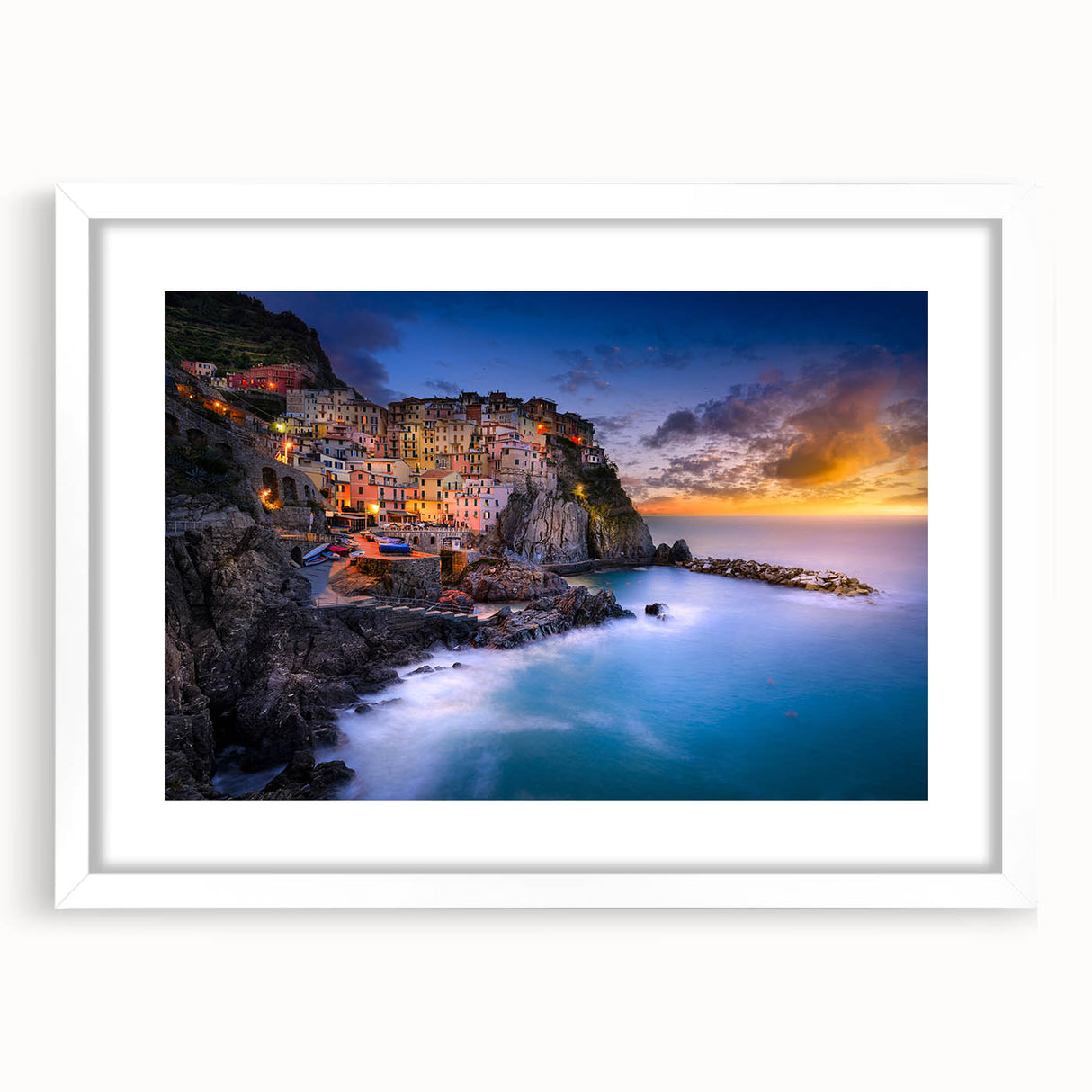 Textured abstract art print of Cinque Terre with vivid blue and green hues on a white framed canvas.