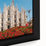 Black wall art featuring a textured depiction of Milan with vibrant color accents on a framed canvas.