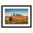 Colorful abstract art print of Tuscany landscape in vibrant hues on a large textured canvas, framed in black.