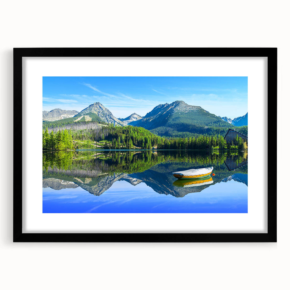Colorful abstract art print of a European scenery in a large black frame, ideal for living room decor.