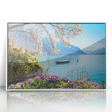 Acrylic print of a serene Swiss landscape, with lush green fields and distant mountains, framed in white.