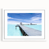 Abstract art print of Cancun scenery in muted blue and green tones, framed with a white mat.
