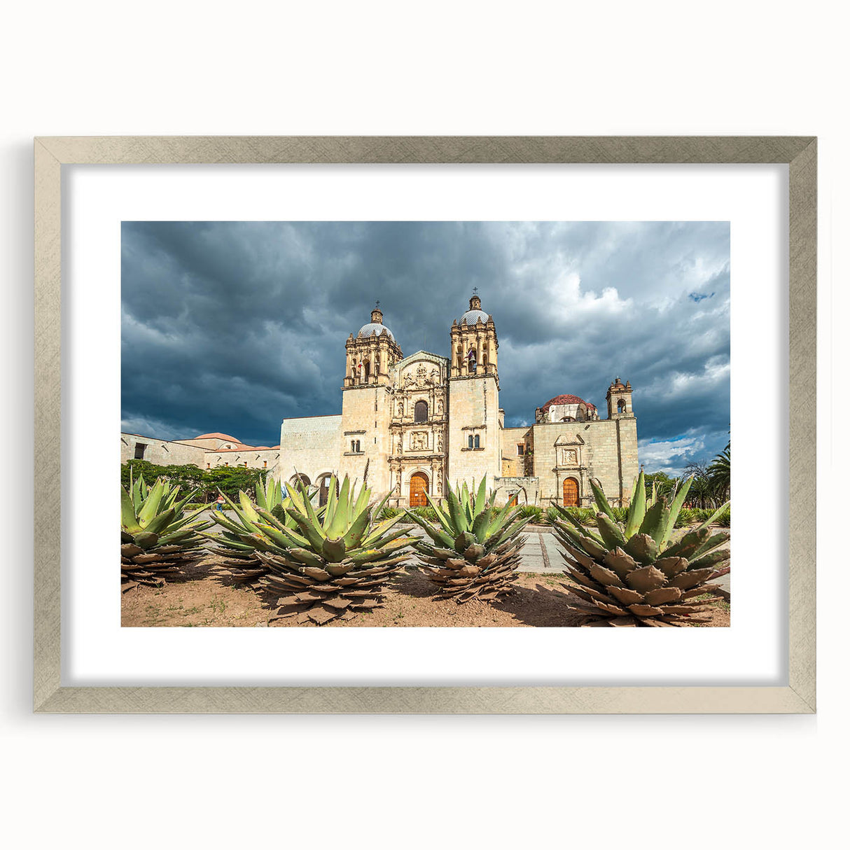 Textured abstract art print of Oaxaca scenery in muted earth tones, framed in silver, suitable for bedroom decor.