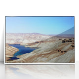 Acrylic print of an Afghan landscape in muted earth tones, framed in white, suitable for modern art wall decor.