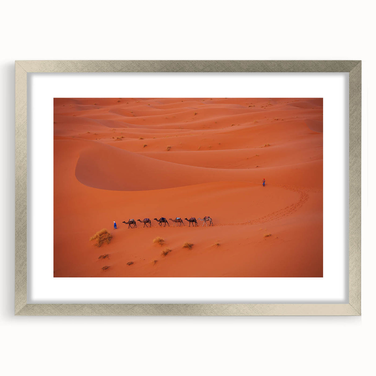 Textured abstract art print of a Middle Eastern scenery in muted earth tones, framed in silver, suitable for bedroom decor.