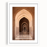 Abstract art print depicting a Middle Eastern desert scene in earth tones on a white matted frame.