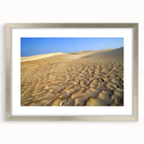 Textured abstract art print depicting a Middle Eastern landscape in muted earth tones, framed with a silver mat.