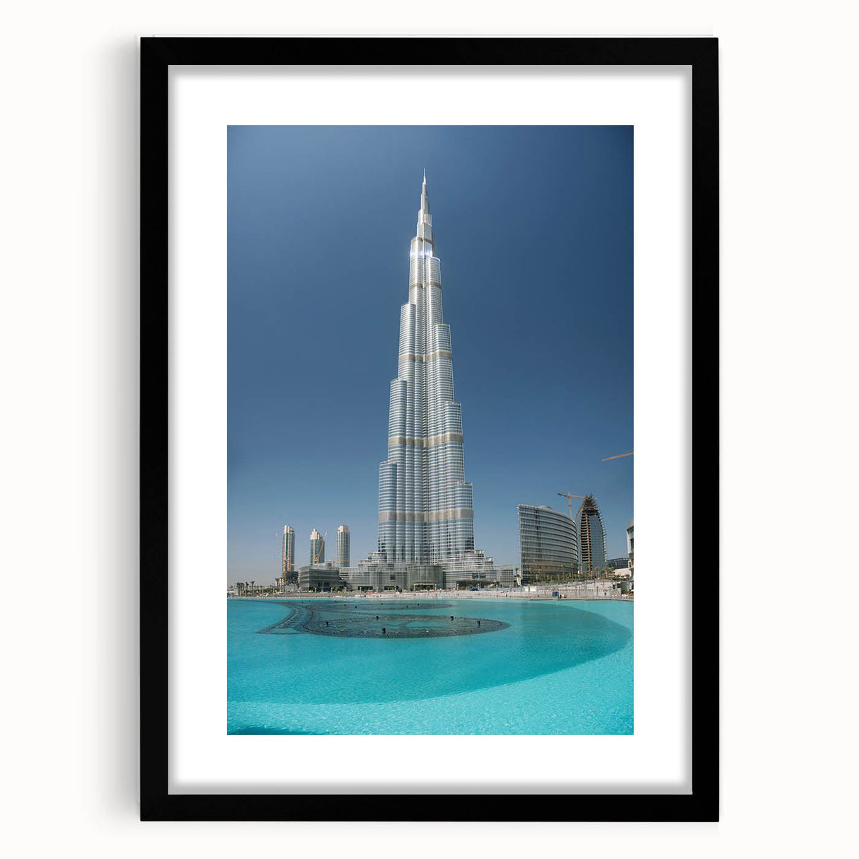 Colorful abstract art print of Burj Khalifa, featuring vibrant blue and orange tones on a large framed canvas.